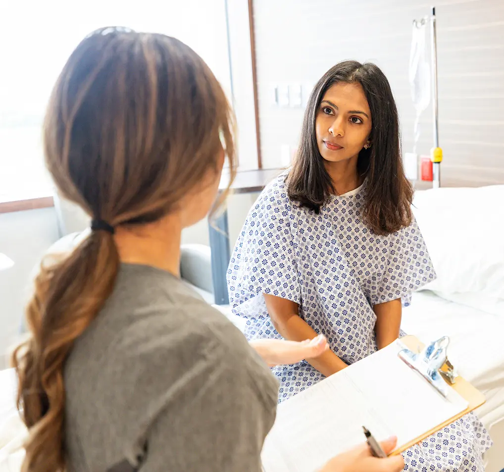 Patient consulting with healthcare professional in hospital.
