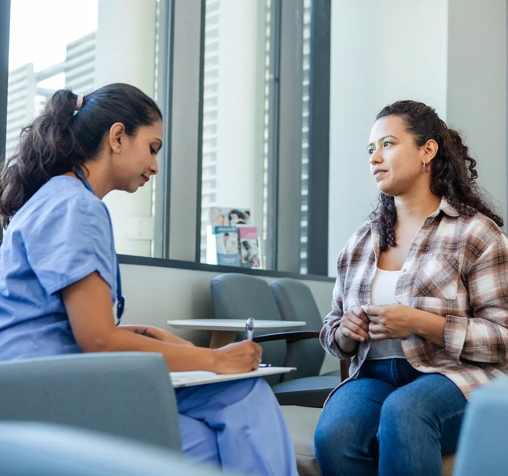 Healthcare professional consulting with a female patient.